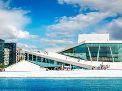 A large modern white building seen from the sea