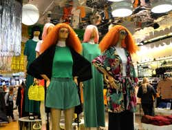 Various mannequins with ginger hair on display in a clothes shop
