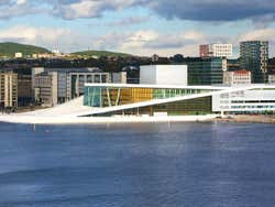 A large modern white building seen from the sea